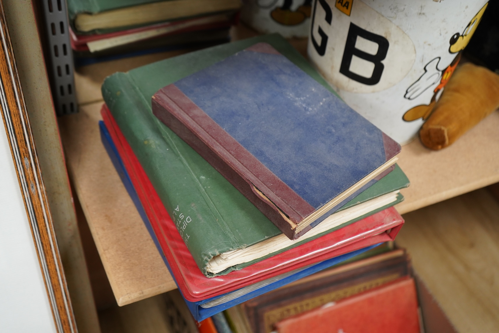 Four stamp albums including a first day cover album